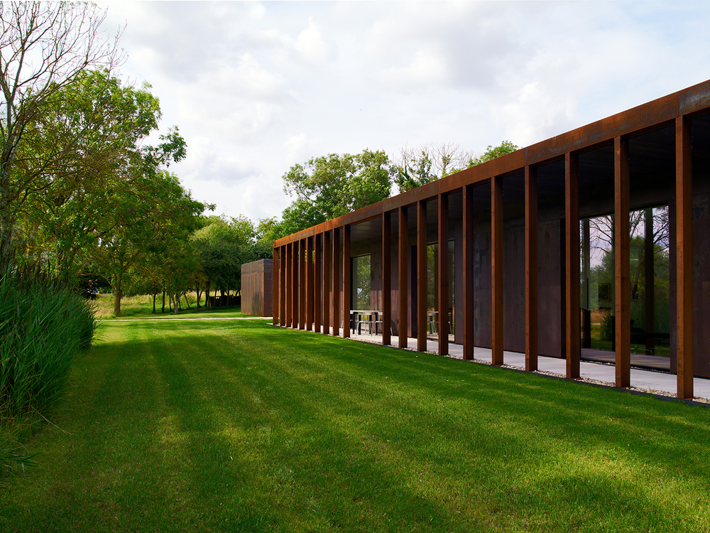 Modern building with glass and wooden pillars.