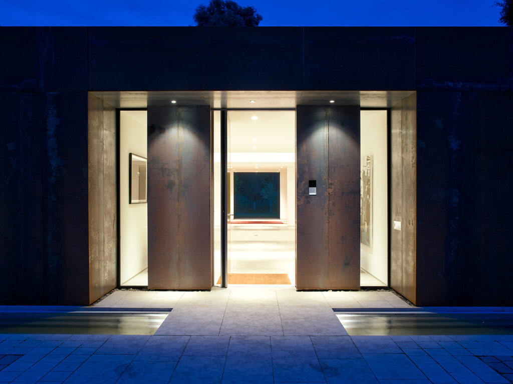 Modern house entrance lit at night