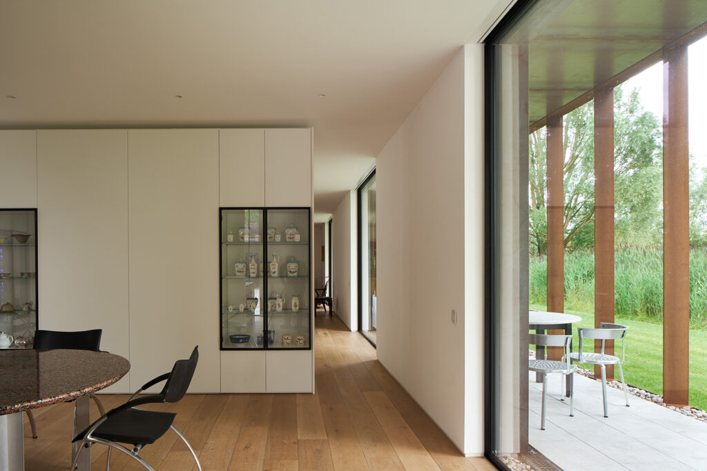 Modern interior with glass cabinet and garden view.